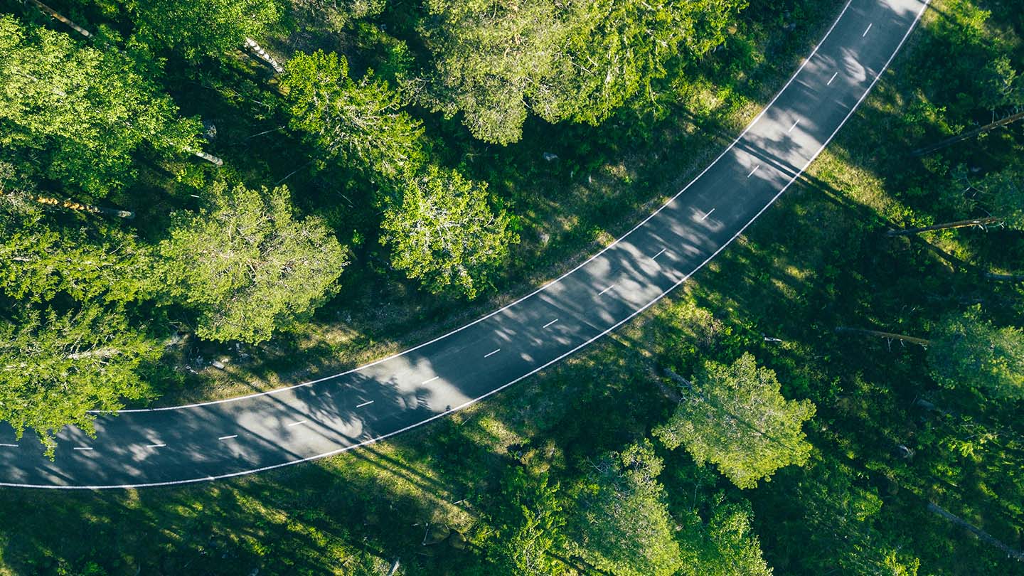 Aerial view of forest road in summer Finland.
